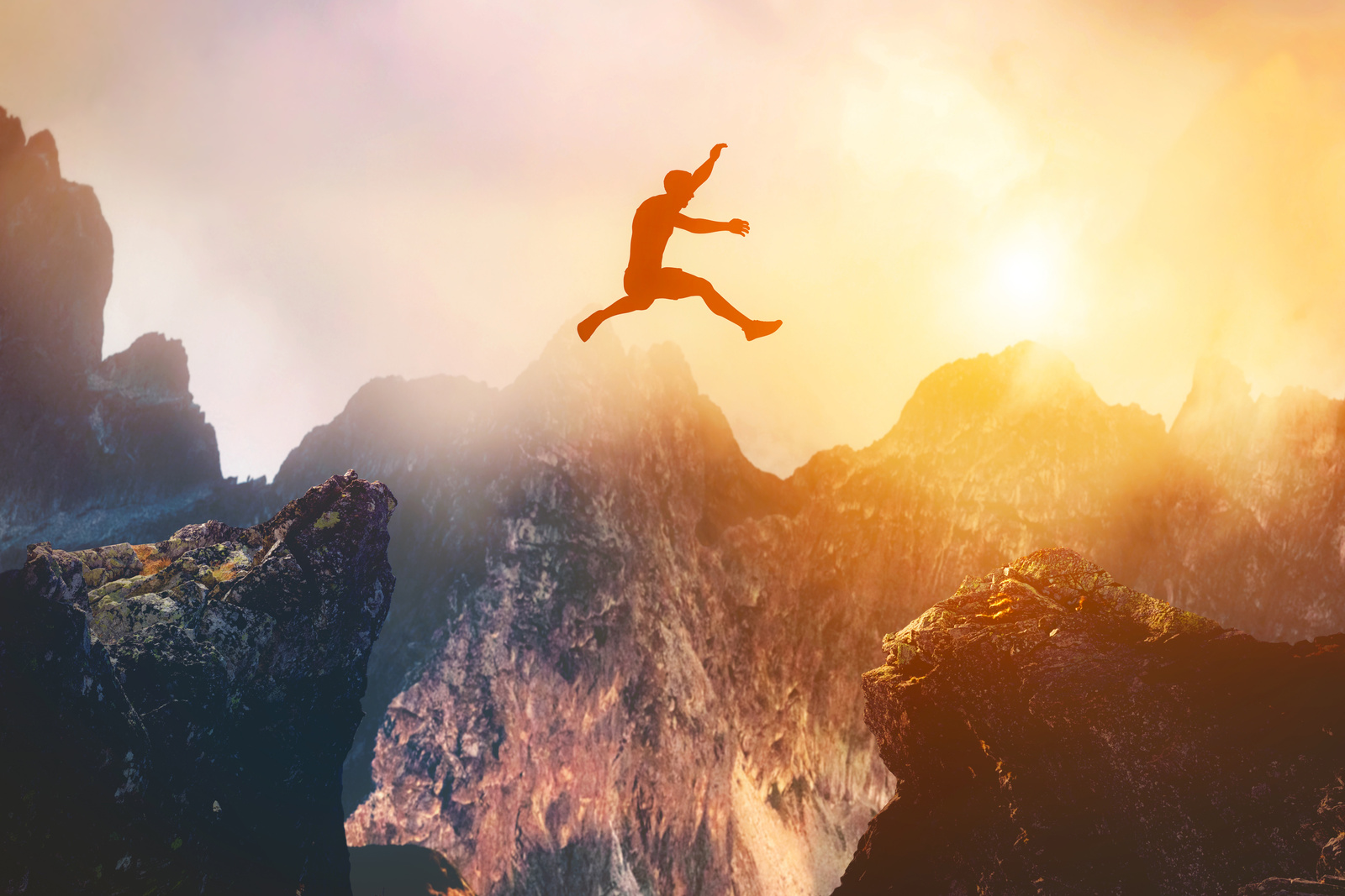 Man Jumping between Rocks